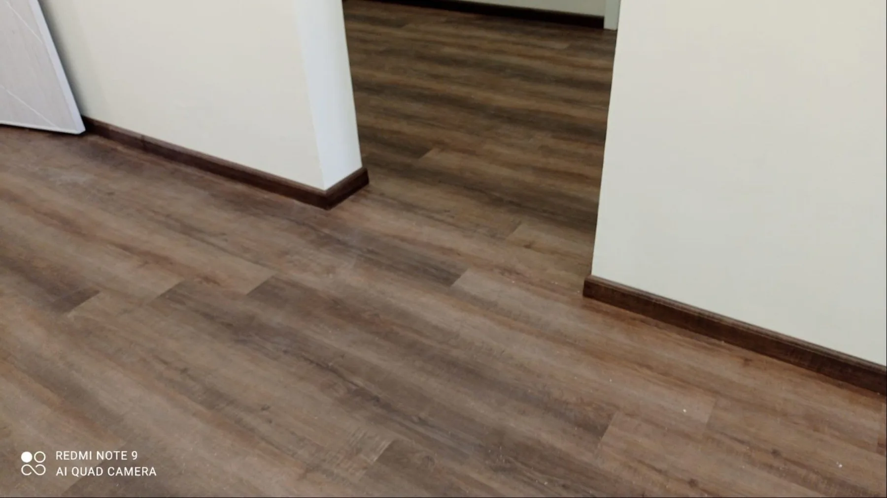 Dark oak flooring and skirting for a hallway